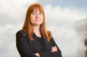 Eve Hill stands in front of cloud background