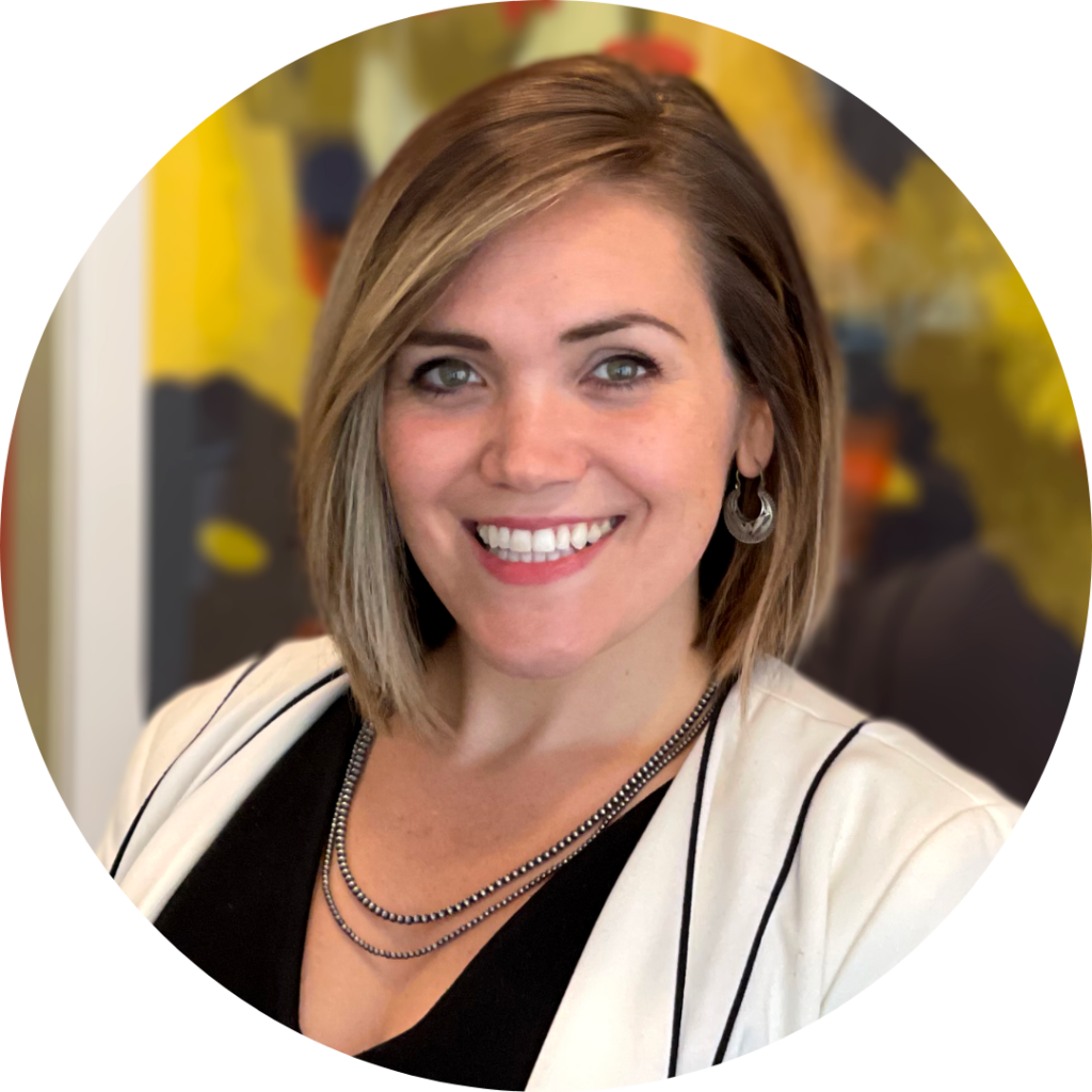 Lauren DiMartino professional headshot. Image of woman smiling and looking directly at camera. She is wearing a white blazer, black top, earrings and a necklace.