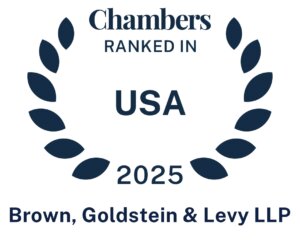 A digital badge featuring a dark blue laurel wreath encircling the text 'Chambers Ranked In USA 2025.' Below the wreath, the law firm name 'Brown, Goldstein & Levy LLP' is displayed in bold. The badge signifies the firm's recognition in the 2025 Chambers USA legal rankings.