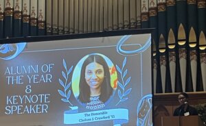 image of The Honorable Chelsea J. Crawford's headshot on a presentation screen with the headline "Alumni of the Year & Keynote Speaker"